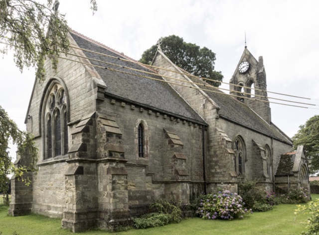 Christ Church, Marton cum Grafton — a Victorian stone church with a clock tower, surrounded by mature trees and summer hydrangeas